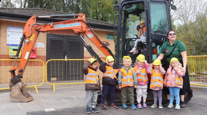 Children smiling by digger